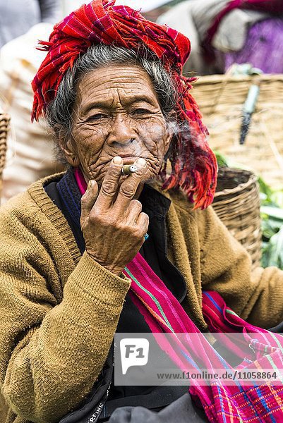Smoking old woman from the Pao hilltribe or mountain people  portrait  market  Kalaw  Shan State  Myanmar  Burma  Asia