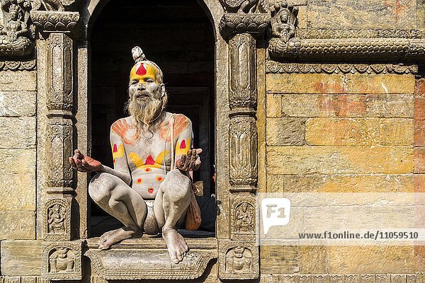 Nacker Sadhu  heiliger Mann  sitzt in einem Hauseingang am Pashupatinath-Tempel  Kathmandu  Nepal  Asien