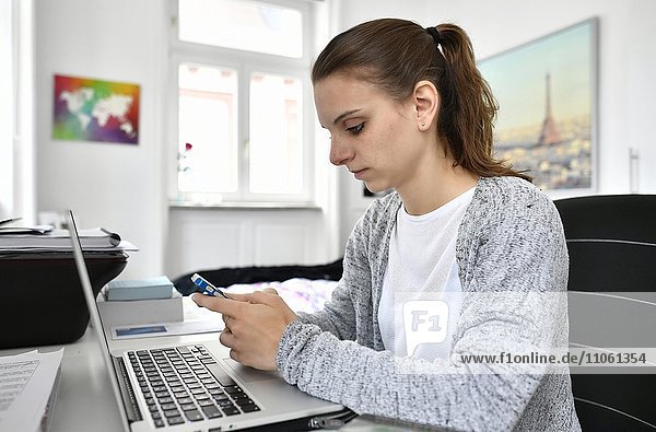 Student with smartphone and laptop  Baden-Württemberg  Germany  Europe