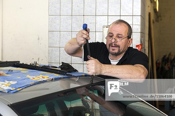Changing the windscreen of a car in a garage for car glass  Düsseldorf  North Rhine-Westphalia  Germany  Europe