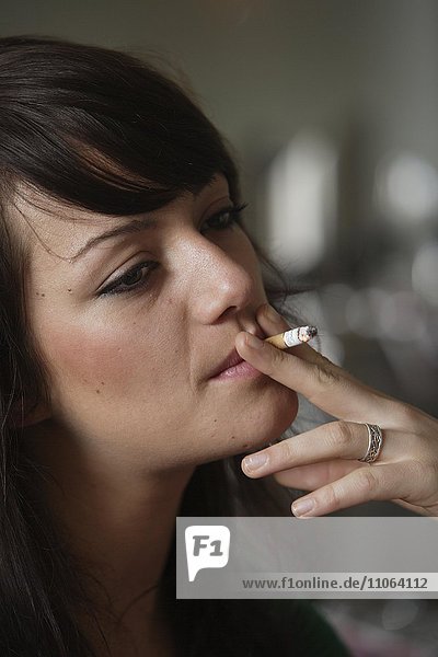 Young woman smoking in a bar or bistro  Germany  Europe