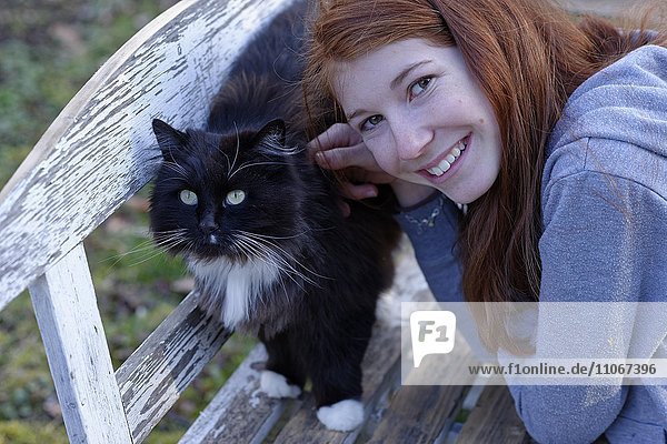 Girl with a black cat  Upper Bavaria  Bavaria  Germany  Europe