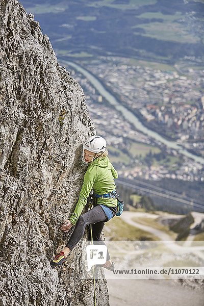 Climber with helmet climbing on a rock wall  behind Innsbruck  Northern Alps  Tyrol  Austria  Europe