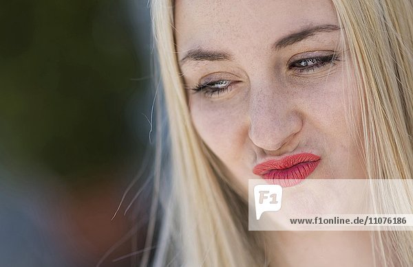 18 year old young woman pouting  long blond hair  portrait