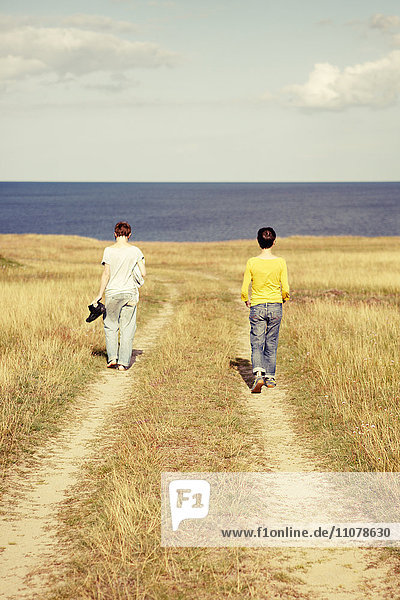 Women walking towards sea