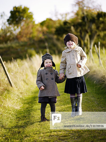Girls walking on field in autumn