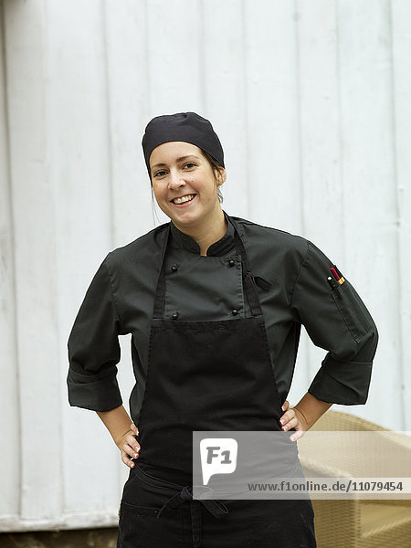 Portrait of smiling woman in chefs clothing