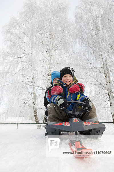 Two boys sledging