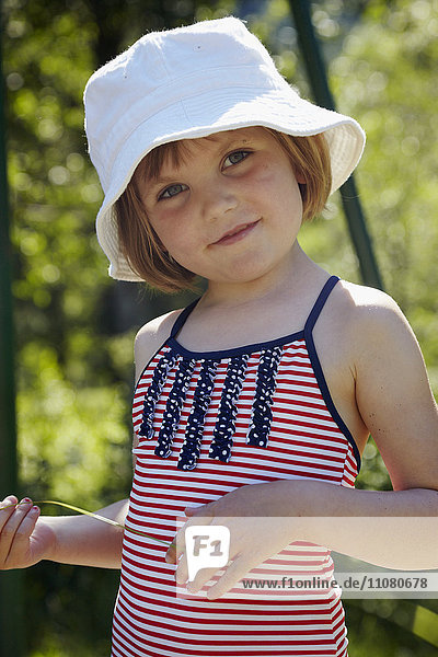 Portrait of smiling girl wearing sun hat