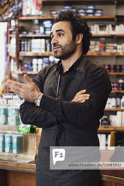 Man gesturing while standing in shoe store