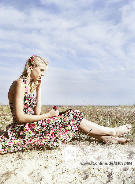 Young woman in floral dress  side view