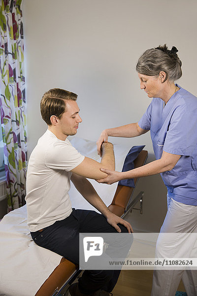 Doctor checking patients arm