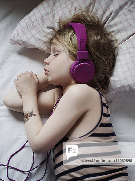 Girl sleeping with headphones