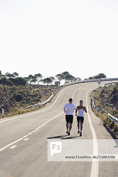 Couple running on road