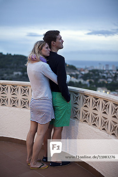 Junges Paar  das sich auf der Terrasse umarmt