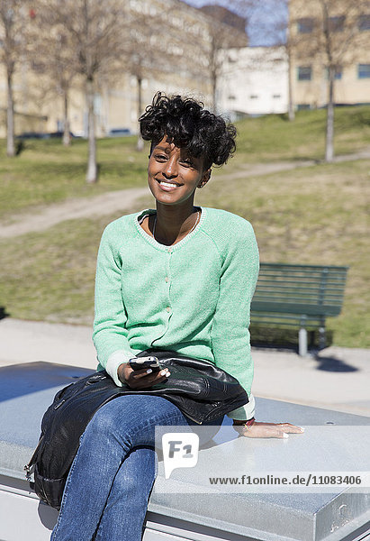 Happy young woman sitting Stockholm Sweden