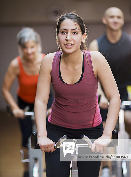 People riding exercise bikes