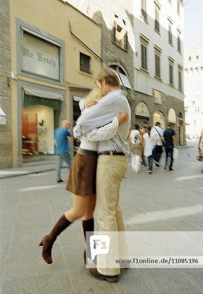 Couple in love walking down a street  Florence  Italy.