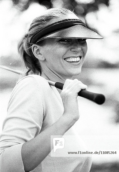 A woman with a golf club