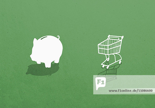 Sparschwein und Einkaufswagen vor grünem Hintergrund