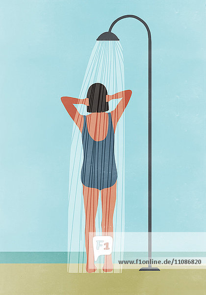 Rear view of woman having outdoor shower at beach