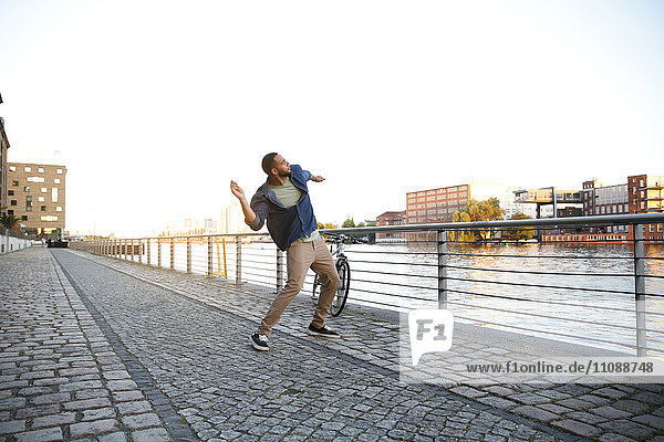 Young man throwing stone into river