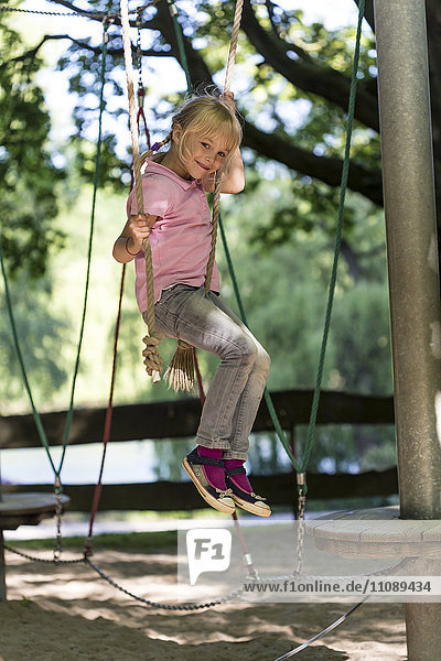 Little girl climbing on a playground