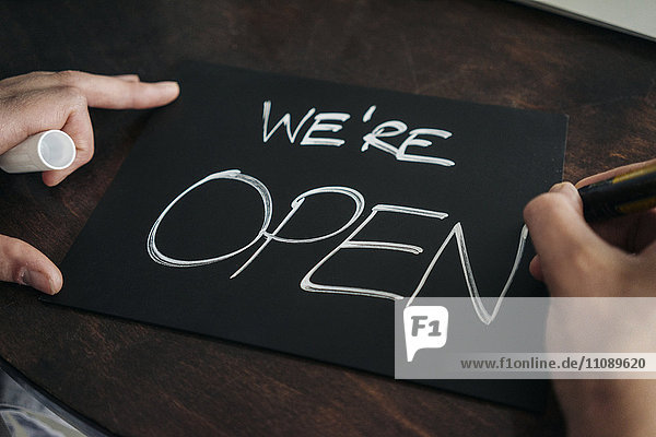 Hand writing open sign