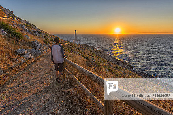Italy  Apulia  Salento  Capo d'Otranto  man admiring the sunrise at lighthouse