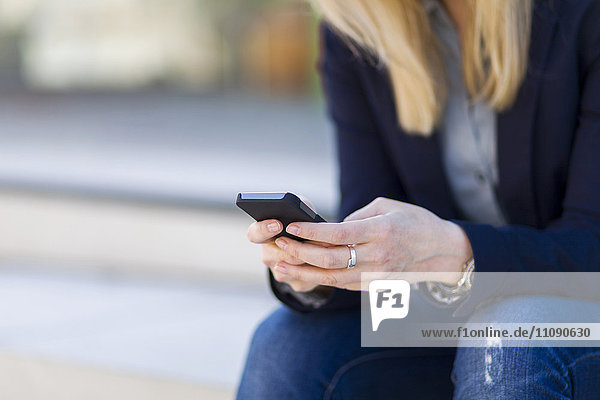 Businesswoman text messaging  close-up
