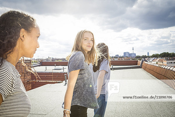Germany  Berlin  three teenage girls on roof top