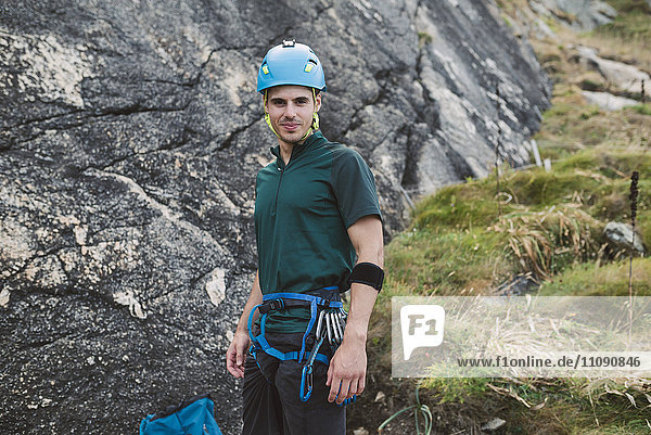 Portrait of confident climber at rock wall
