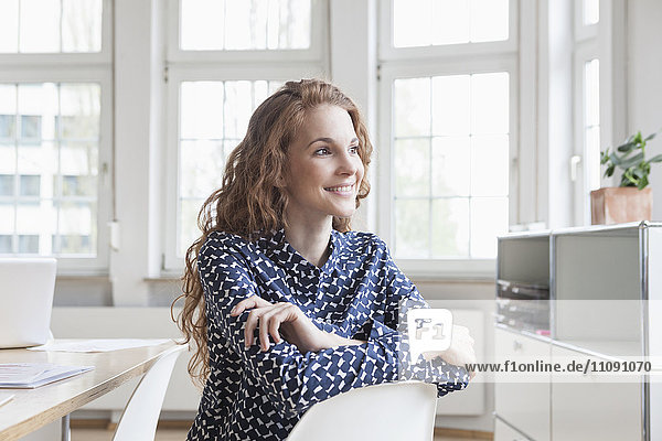 Smiling woman at desk in office