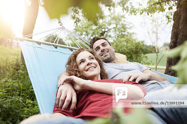 Smiling couple relaxing in hammock