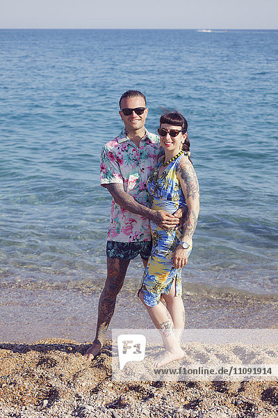 Tattooed couple on the beach