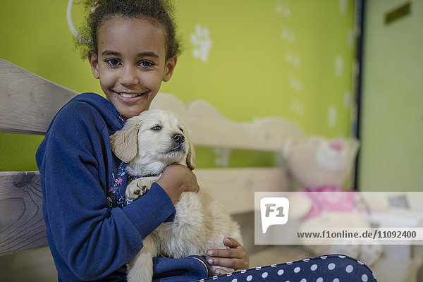 Girl holding labrador puppy at the veterinarian