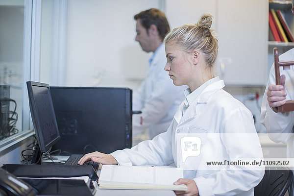 Young woman working on computer in lab