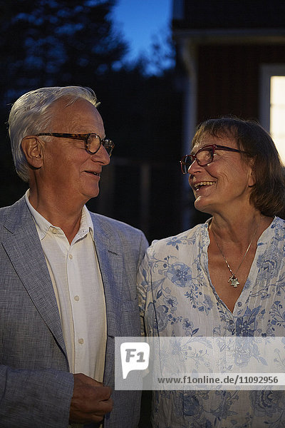 Senior couple smiling face to face