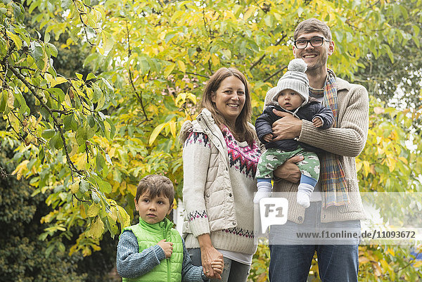 Portrait of a nuclear family standing in an organic farm and smiling