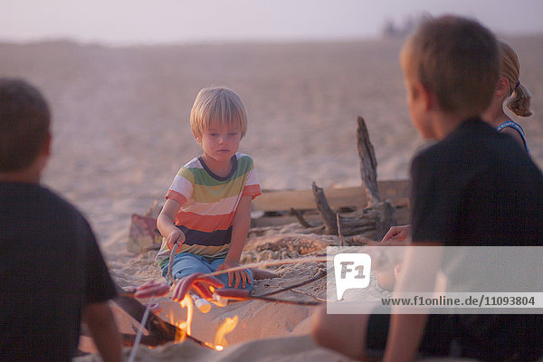 Boy with his friends enjoying camping on the beach