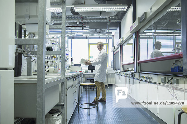 Young male scientist working in a pharmacy laboratory