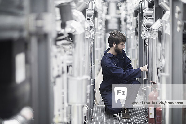 Young male engineer working in an industrial plant