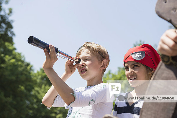 Children playing pirate game in adventure playground  Bavaria  Germany