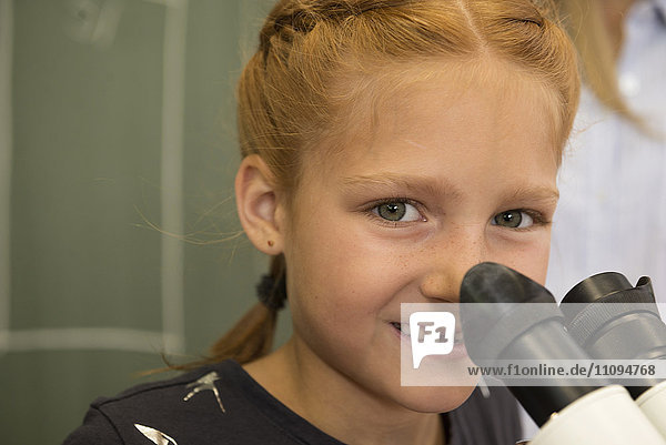 Close-up of a School girl smiling with microscope  Fürstenfeldbruck  Bavaria  Germany