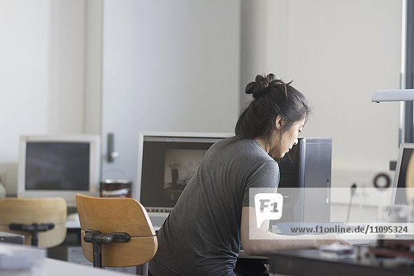 Young female engineer working on computer in an office  Freiburg im Breisgau  Baden-Württemberg  Germany