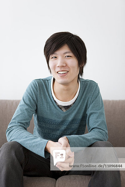 Young Man Sitting on Sofa