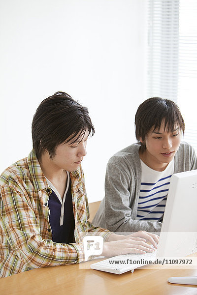 Young Men Using Computer