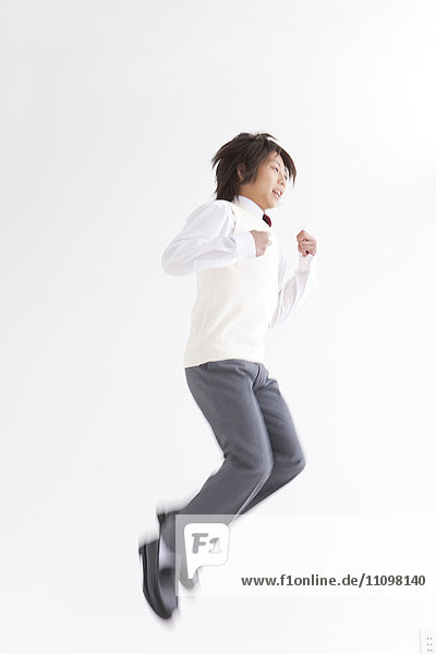 School Boy in Uniform Jumping