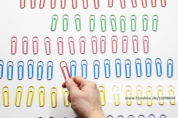 Hand holding paper clips
