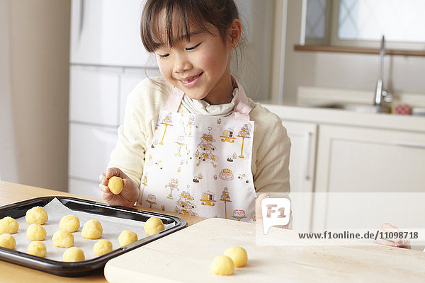 Girls kneading bread dough